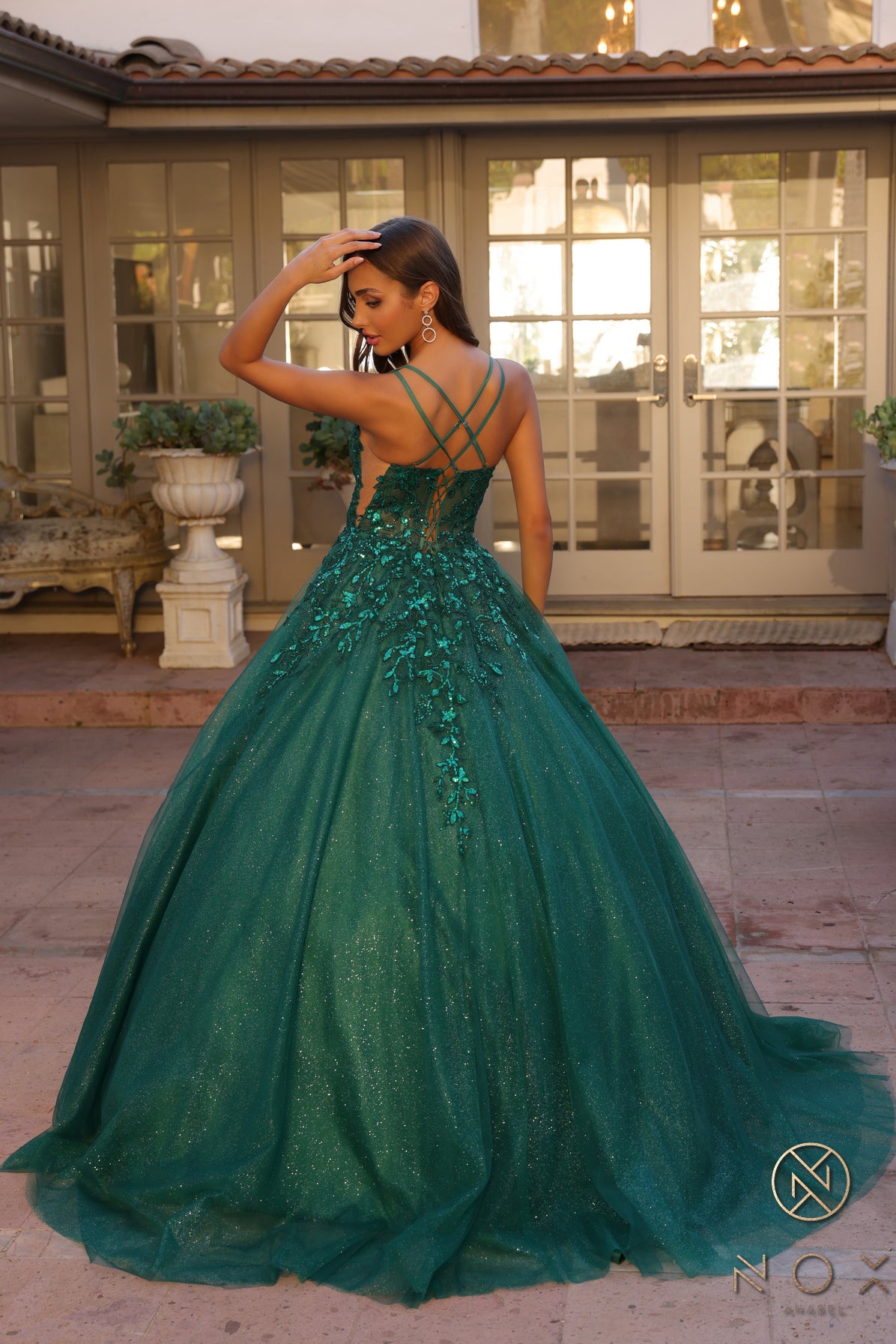 Elevate your prom night look with the Nox Anabel H1271 dress. This elegant A-line gown features a stunning shimmering tulle design with a sheer sequin corset and a flattering scoop neck. Perfect for making a statement with a touch of glamour.  Sizes: 00-16  Colors: Green, Fuchsia, Lavender