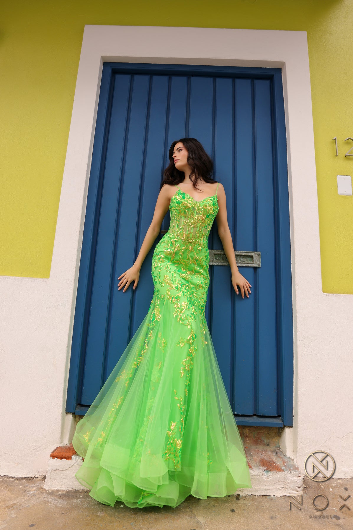 Elevate your prom or pageant look with the Nox Anabel Q1390 Prom Dress. Featuring a long sequin body with a sheer corset and mermaid silhouette, this dress will have you shining all night. Stand out in vibrant neon while feeling confident and elegant.  Sizes: 0-16  Colors: Neon Green, Neon Orange, Coral Fuchsia, Ocean Blue