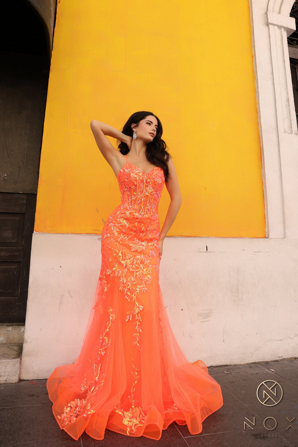 Elevate your prom or pageant look with the Nox Anabel Q1390 Prom Dress. Featuring a long sequin body with a sheer corset and mermaid silhouette, this dress will have you shining all night. Stand out in vibrant neon while feeling confident and elegant.  Sizes: 0-16  Colors: Neon Green, Neon Orange, Coral Fuchsia, Ocean Blue