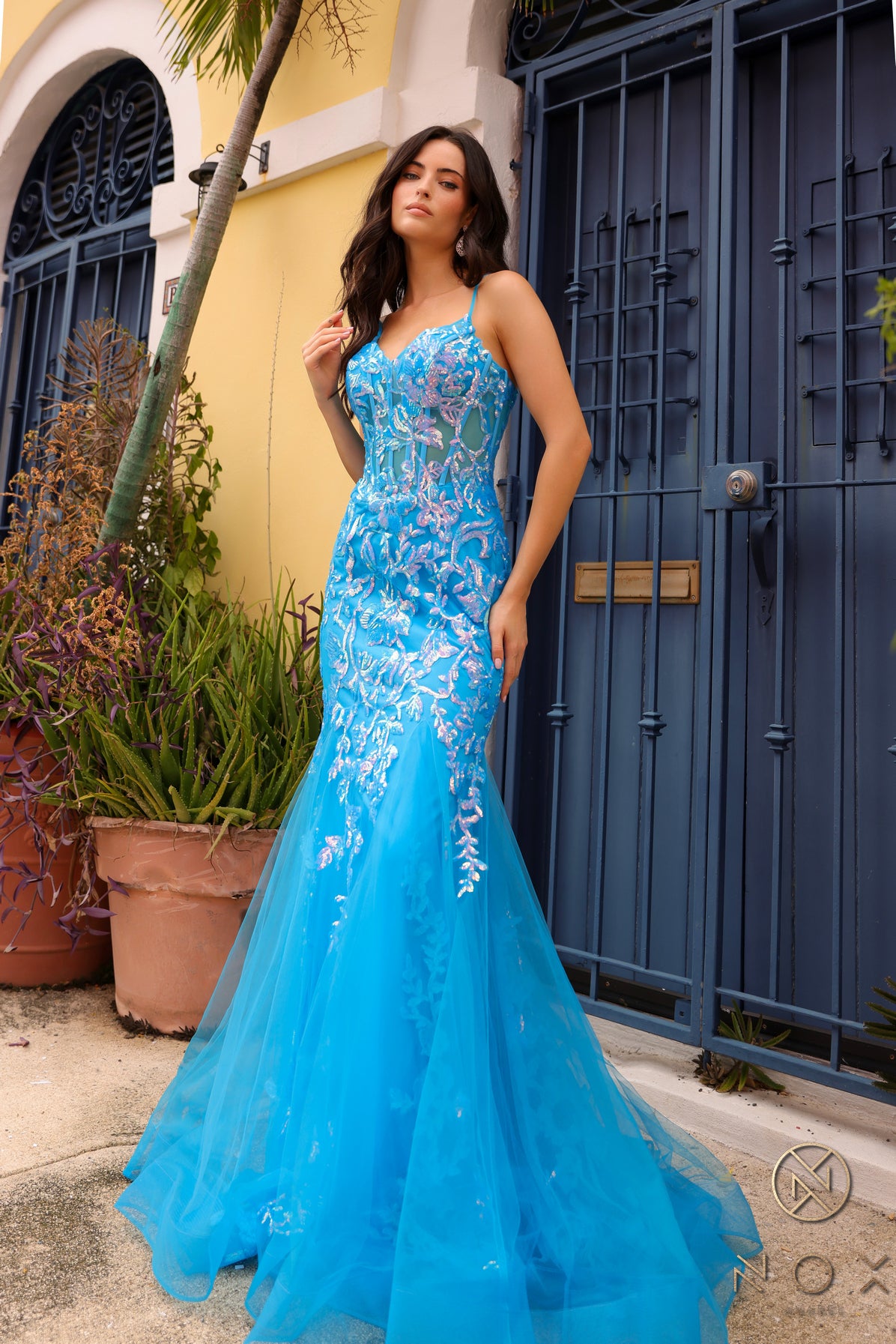 Elevate your prom or pageant look with the Nox Anabel Q1390 Prom Dress. Featuring a long sequin body with a sheer corset and mermaid silhouette, this dress will have you shining all night. Stand out in vibrant neon while feeling confident and elegant.  Sizes: 0-16  Colors: Neon Green, Neon Orange, Coral Fuchsia, Ocean Blue