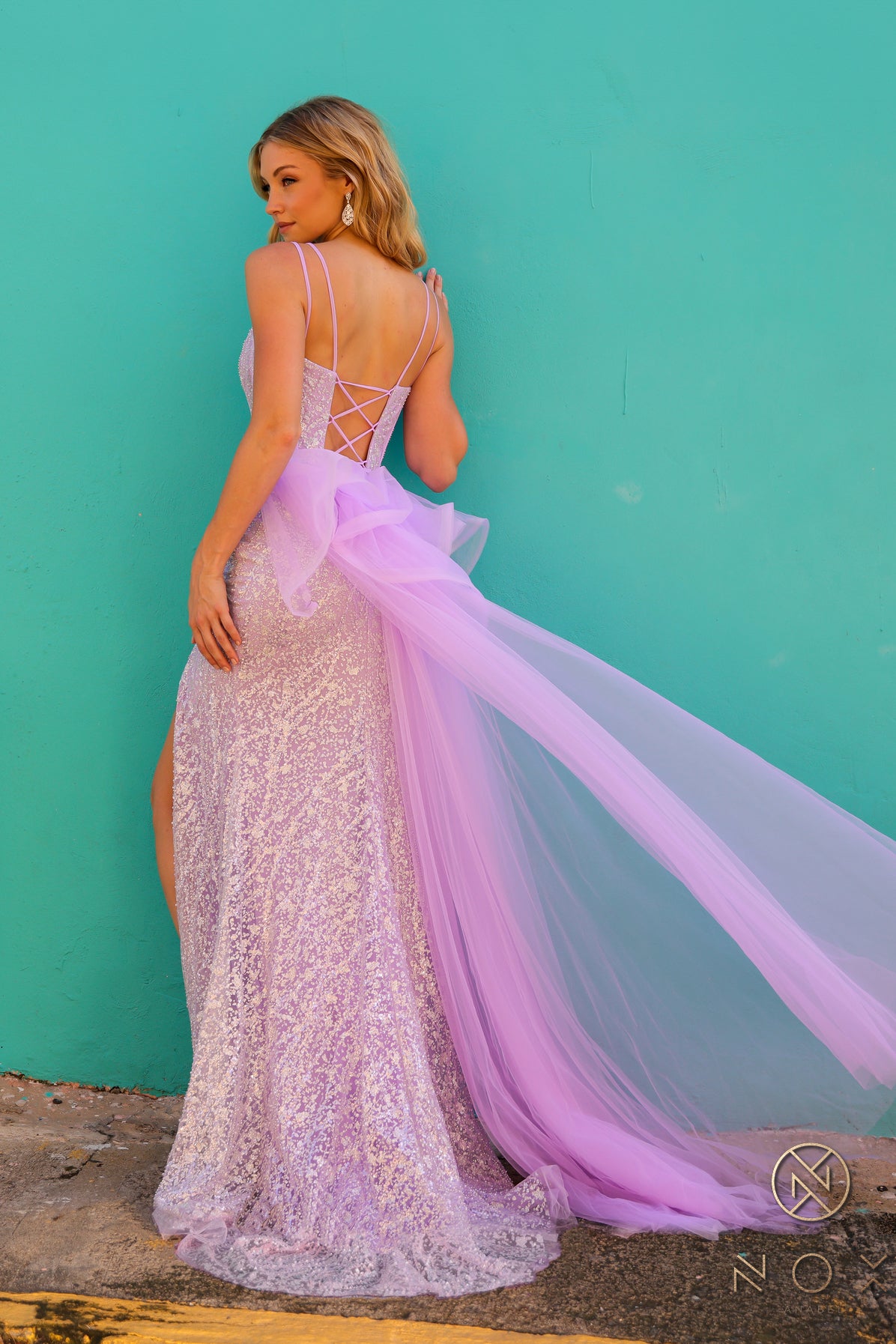 Elevate your look with the Nox Anabel Y1475 Long Beaded Prom Dress. The ruffle top and corset detailing create a flattering silhouette while the beaded overskirt adds a touch of glamour. Perfect for formal events and pageants, this gown is sure to impress.

Sizes: 4-16

Colors: Lilac, White