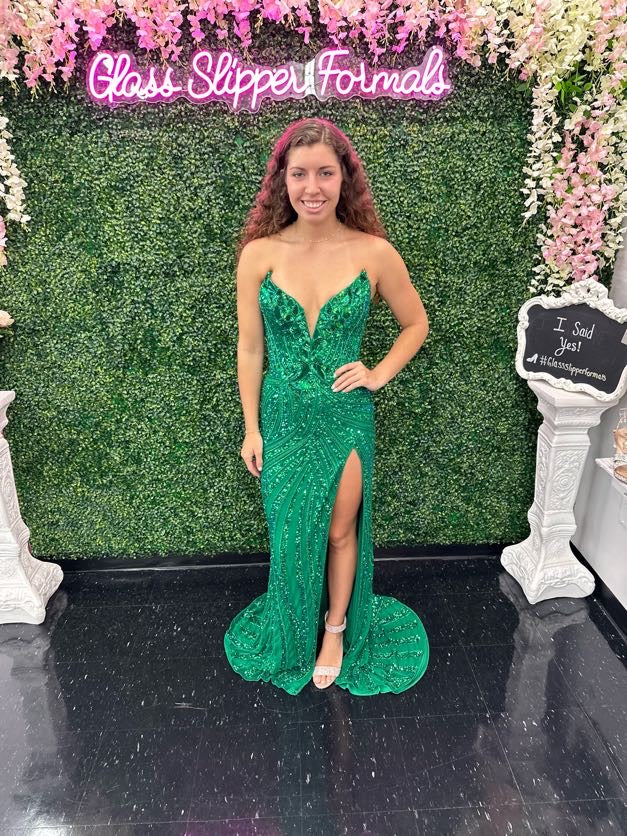 Ashley Lauren 11236 Long Fitted V Neck Slit Beaded Sequin Prom Dress Pageant Gown This strapless gown is sure to turn heads. The sweetheart neckline is complete with a modern floral sequin motif that continues down the bustier and skirt. The skirt is complete with a left leg slit.