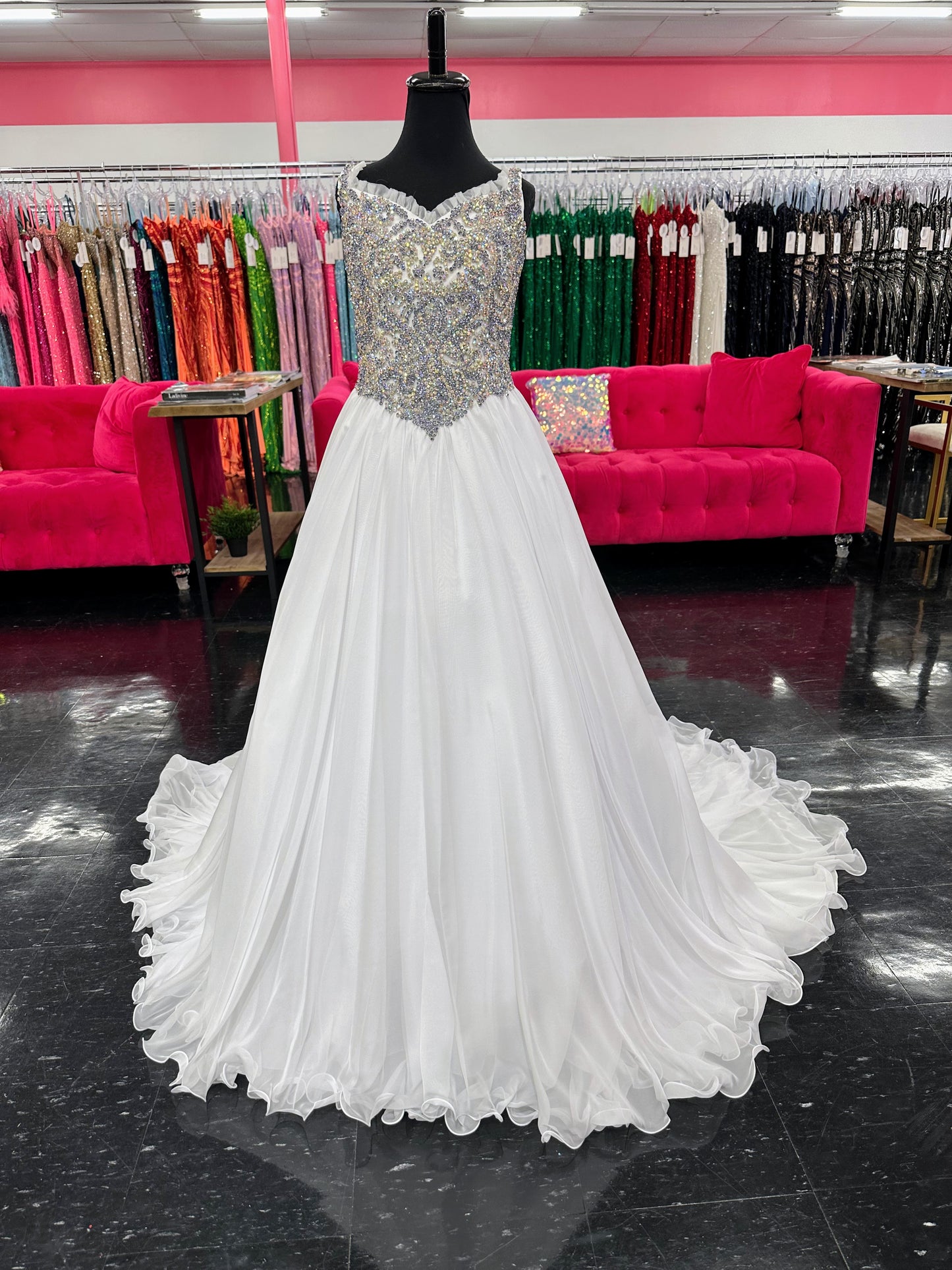 Experience the luxurious elegance of the Samantha Blake 1127 Pageant Dress. Made with soft, lightweight chiffon, this A-line ballgown will have your little girl feeling like a true princess. The crystal embellished bodice and ruffle trim neckline add a touch of sparkle and charm. Perfect for any pageant or special occasion.