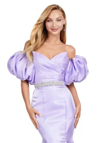 Expertly crafted by Ashley Lauren, this 11419 Long Prom Dress boasts a stunning mermaid silhouette with a strapless design and luxurious satin fabric. The oversized puff sleeves add a bold and elegant touch, making you stand out at any formal event or pageant. Elevate your look with this timeless and sophisticated gown.  Voluminous puff sleeves and a classic sweetheart neckline frame this stunning gown. With its mermaid fit and jeweled belt, this gown is a dream come true!