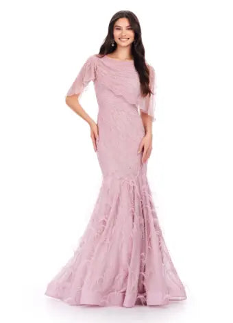 Make a statement in the Ashley Lauren 11431 Long Prom Mermaid Dress. This elegant gown features intricate beading and an asymmetrical cape, creating a stunning silhouette that will turn heads. Perfect for formal occasions and pageants, this dress will make you feel confident and glamorous. Classy with a twist. This fully beaded gown features a sheer asymmetric cape and feathers throughout the skirt.