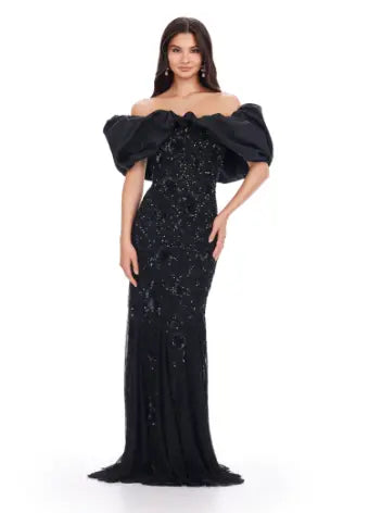 The Ashley Lauren 11433 long prom dress features a beaded off shoulder design and oversized ruffle detailing, making it the perfect formal pageant gown. Its elegant and figure-hugging silhouette is sure to make you stand out among the crowd. Channel your inner pageant queen and capture everyone's attention with this stunning dress. A fully beaded gown sure to steal the show. This gown features an oversized off shoulder taffeta ruffle taking this look to the next level.