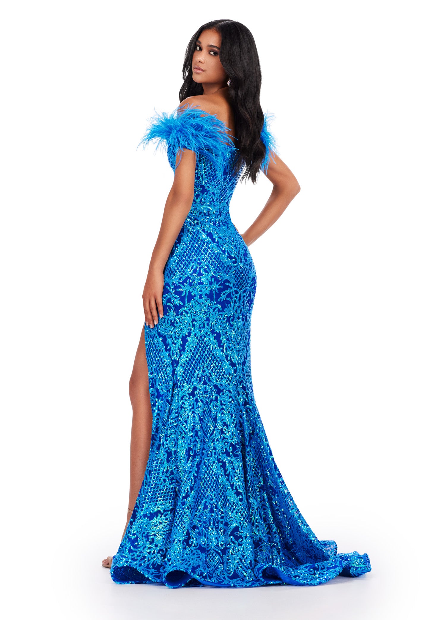 Elevate your prom look with the stunning Ashley Lauren 11463 Long Sequin Mermaid Prom Dress. The off the shoulder design and feather embellishments add a touch of glamour, while the slit detail adds a touch of flirtiness. This dress is perfect for making a statement on your special night. Stand out in this off the shoulder stretch sequin gown. We are living for this sweetheart neckline and feather details.