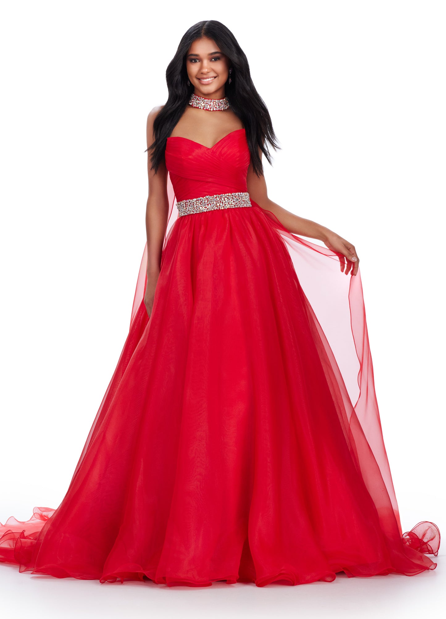 The Ashley Lauren 11565 Long Prom Dress is a stunning organza ball gown that features a beaded choker and a flowing cape, perfect for formal events or pageants. With its intricate beading and elegant design, this dress will make you feel like a true princess. A dress sure to make you feel like a queen. This strapless organza ball gown features a beaded waist band. The look is finished with a beaded choker and organza cape.