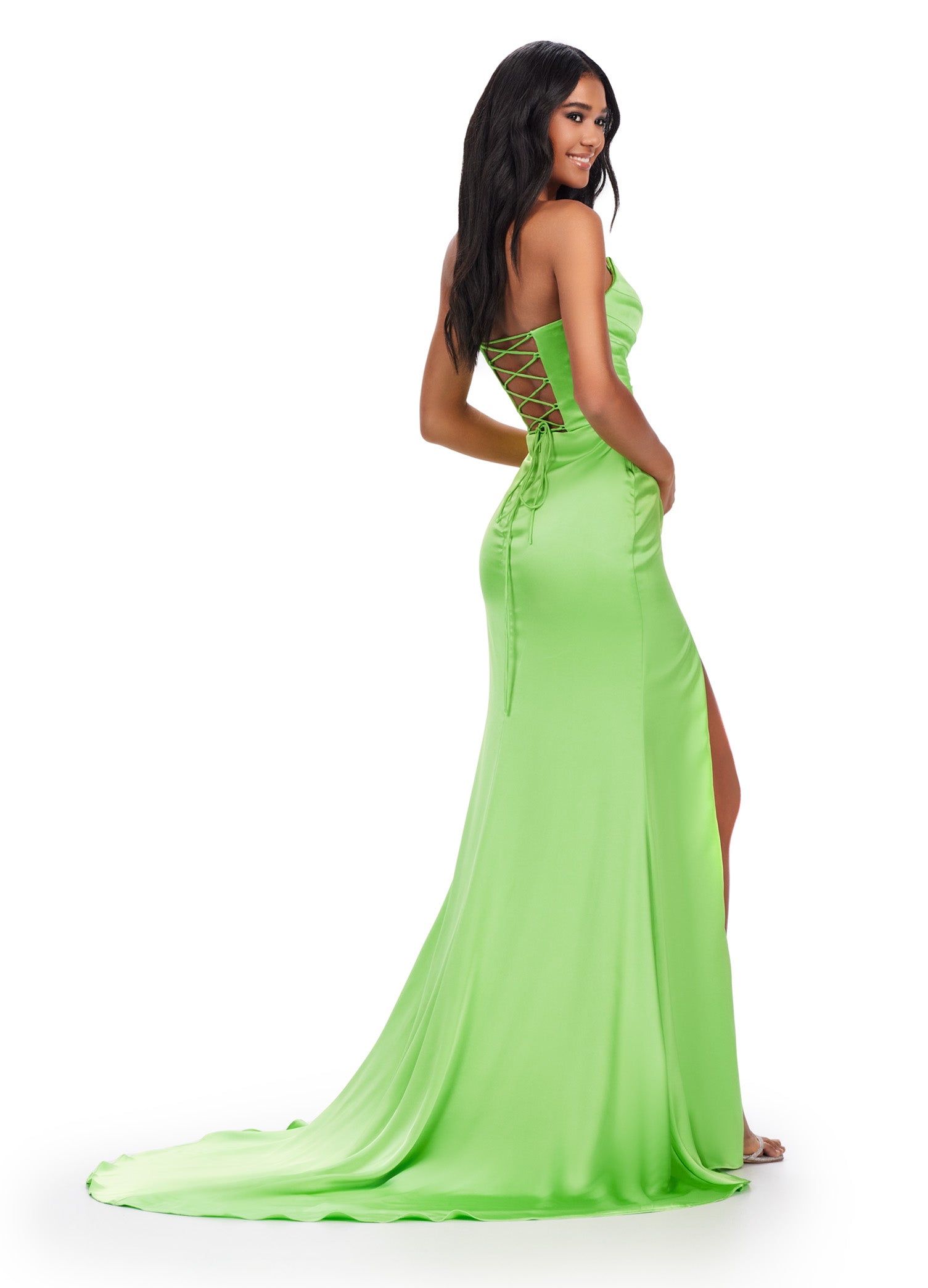 Get ready to make a statement in the Ashley Lauren 11605 Long Prom Dress. This stunning gown features a strapless sweetheart neckline and a satin material that will hug your curves in all the right places. The lace-up back and thigh-high slit add a touch of drama and sophistication. Stand out at your next formal event with this elegant and stylish prom dress. A timeless classic! This strapless satin dress features ruched detail throughout. The lace up back and right leg slit complete the look.