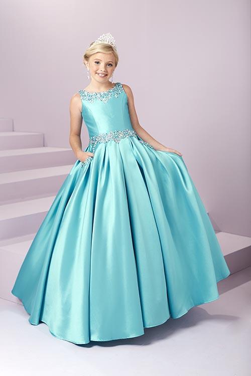 Expertly designed for the modern princess, the Tiffany Princess 13485 Girls Pageant Dress is a stunning Mikado A Line masterpiece. Embellished with intricate beadwork and featuring convenient pockets, this open back ball gown will make any young lady feel like royalty. <span data-mce-fragment="1">A beaded scoop neckline and waistband showcase this adorable gown. Complete with a box pleated, a-line mikado skirt with front Pockets, and an open back with lace-up.</span>