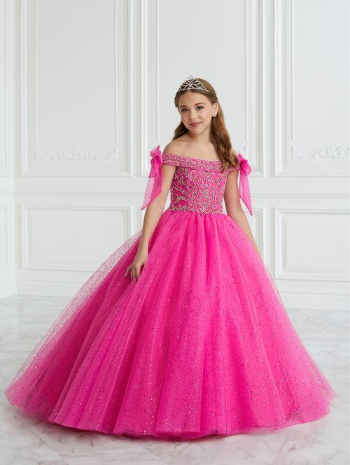 This Tiffany Princess pageant dress Style 13677 features a stunning A-line design with intricate beading and glitter details. The tulle ball gown is completed with delicate off the shoulder neckline accented by bows for added elegance. Perfect for formal events, this dress will make your little girl feel like a princess. Corset Back