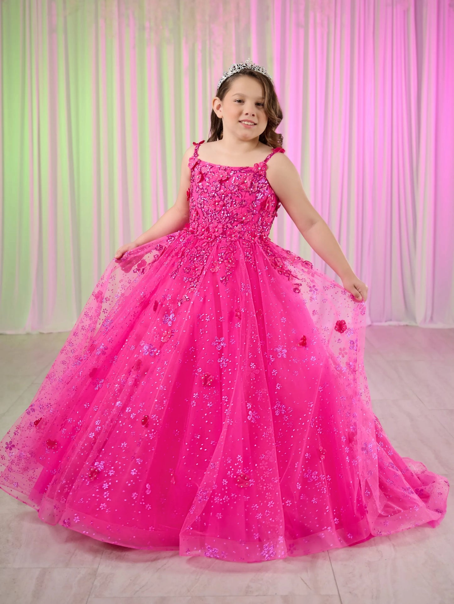 Dress your little princess like royalty with our Tiffany Princess 13758 Long Lace Pageant Dress. The stunning scoop neckline and spaghetti straps enhance a regal look. Adorned with 3D floral and glitter details, the tulle ball gown skirt adds a touch of elegance. The lace-up back and sweep train complete the fairytale feel of this dress.