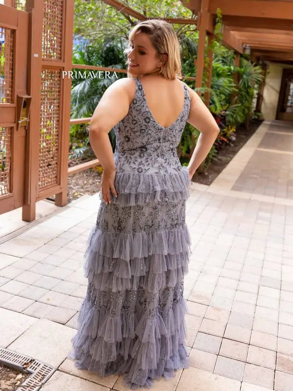 This elegant Primavera Couture 14052 prom dress is designed to showcase your curves with its long, fitted silhouette. The sequin detailing adds a touch of glamour, while the tiered skirt adds movement and volume. Perfect for formal occasions, this plus size gown is sure to turn heads.