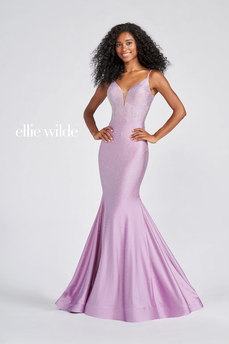 Look stunning in this Ellie Wilde EW120012 prom dress. This gorgeous mermaid-style gown has a backless crystal jersey design and sparkling crystal appliqué detailing that will make you shine on the dance floor. The fitted jersey fabric ensures that you’ll look your best in this dazzling gown. Sleeveless novelty stretch fit and flare gown with a plunging V-neck, natural waist, stone accents throughout gown, open bandeau back, horsehair hem and a sweep train.