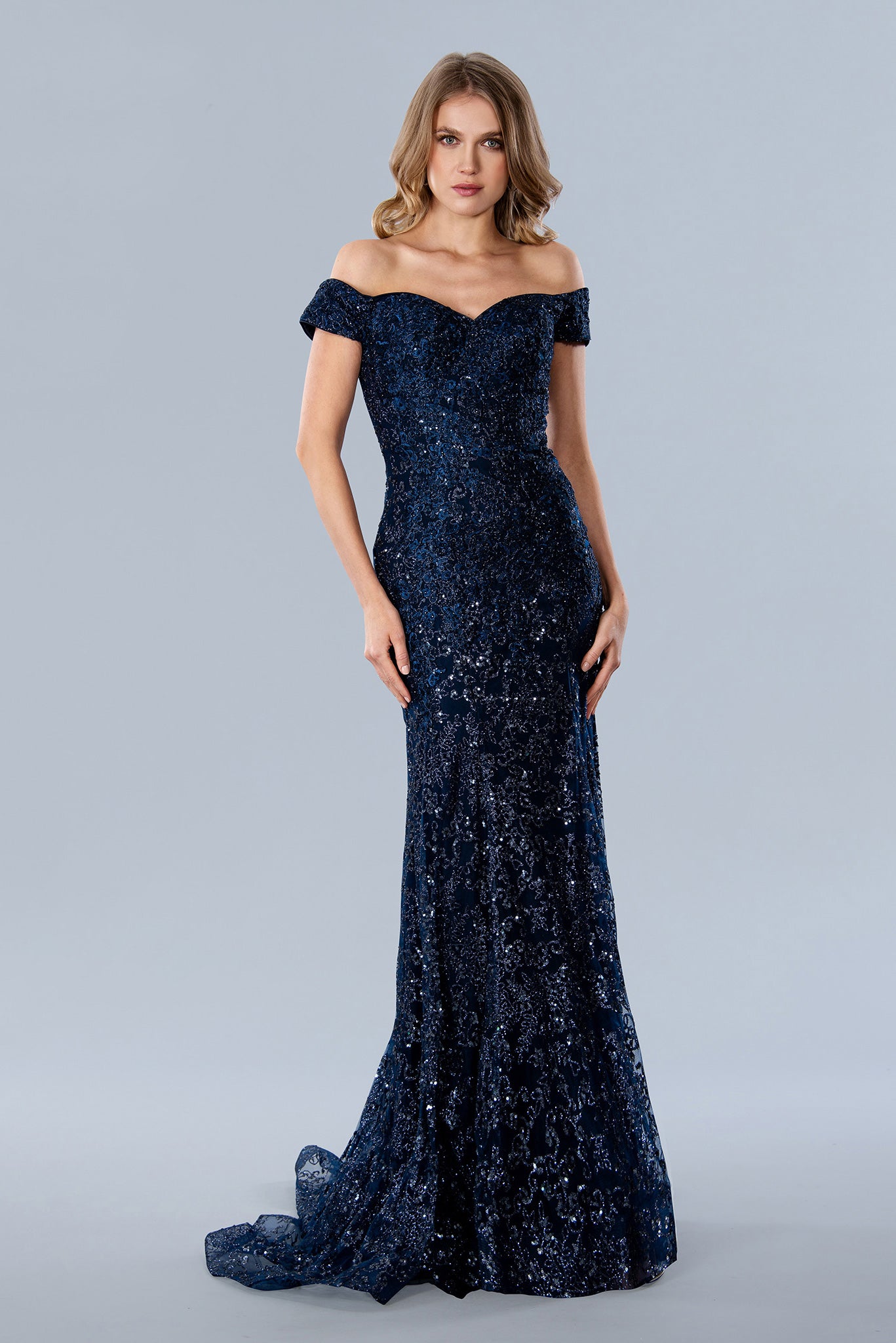 Stella Couture 22069 shimmer Glitter dress offers a stunningly glamorous look for prom. The fitted silhouette and off-the-shoulder design create an elegant, flattering shape, while sparkling glitter fabric adds a touch of glamour. Perfect for making a statement at your prom or special event. 