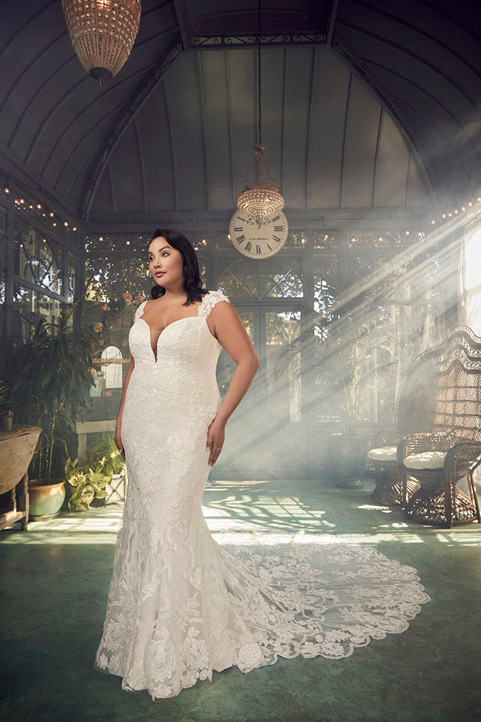 A portrait of timeless beauty, Justine Style 2485 by Casablanca Bridal is a vision of romanticism and femininity. Crafted from exquisite stretch chiffon, this figure-loving fit and flare silhouette features a plunging neckline and wide straps that frame a low-cut laced back. 