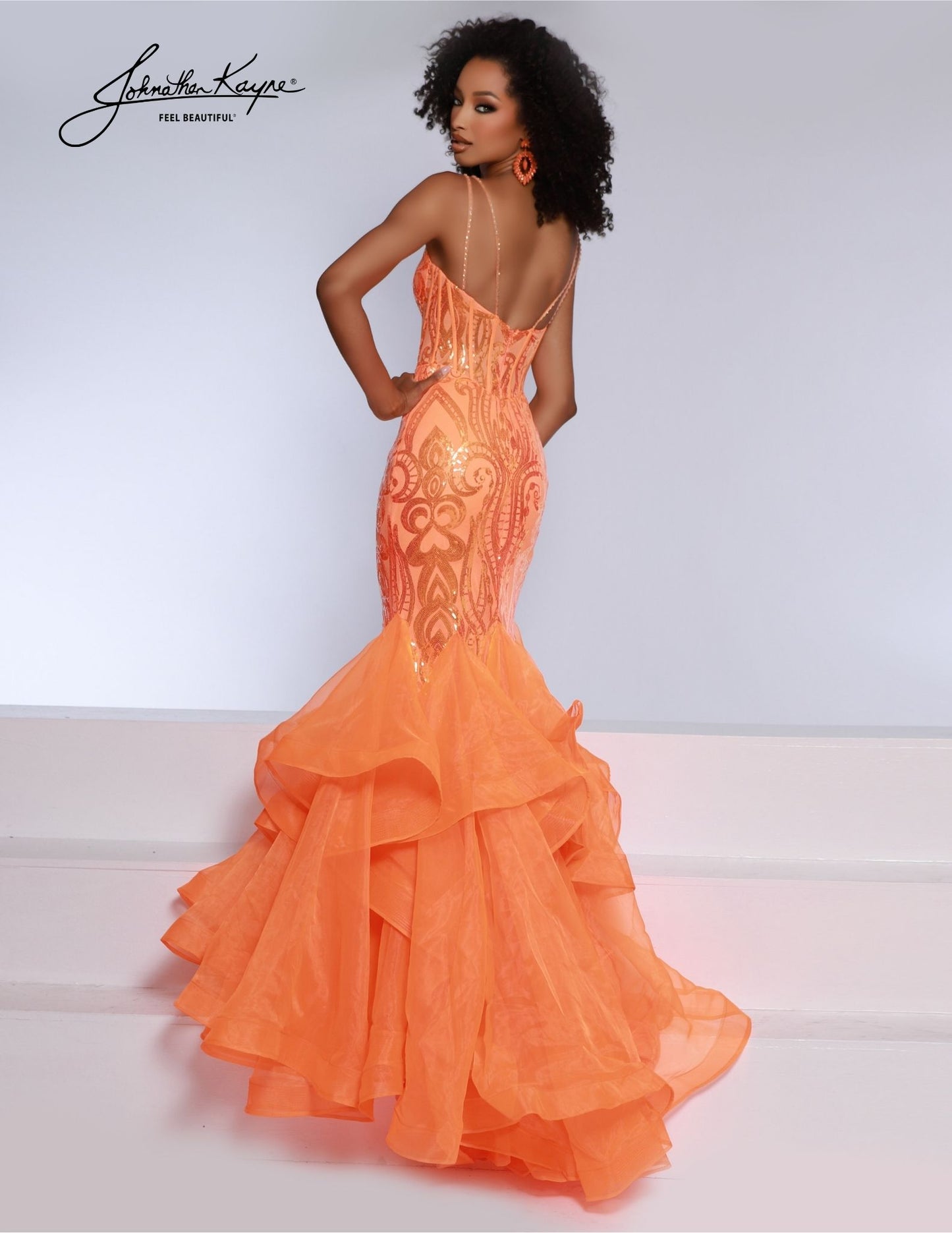 This Johnathan Kayne 2835 Long Prom Dress features a ruffled mermaid corset, V-neck, and a formal pageant gown design. The mermaid silhouette and exposed boning bodice create a unique, flattering hourglass shape that accentuates your curves while adding a dramatic touch to your look.