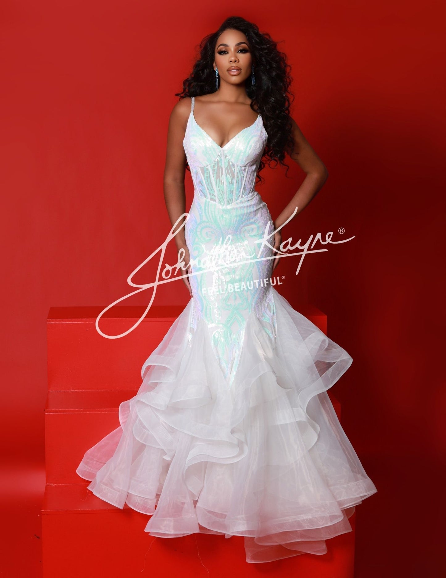 This Johnathan Kayne 2835 Long Prom Dress features a ruffled mermaid corset, V-neck, and a formal pageant gown design. The mermaid silhouette and exposed boning bodice create a unique, flattering hourglass shape that accentuates your curves while adding a dramatic touch to your look.