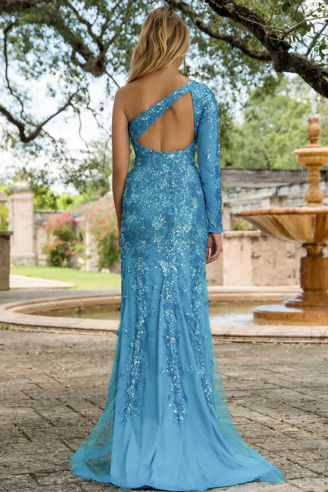 This stunning Ava Presley 28578 long prom dress features a one shoulder design with an intricate sequin pattern. The high slit and cape sleeve add a touch of elegance to this formal gown, making it perfect for any pageant or special occasion. Make a statement and stand out in style with Ava Presley.