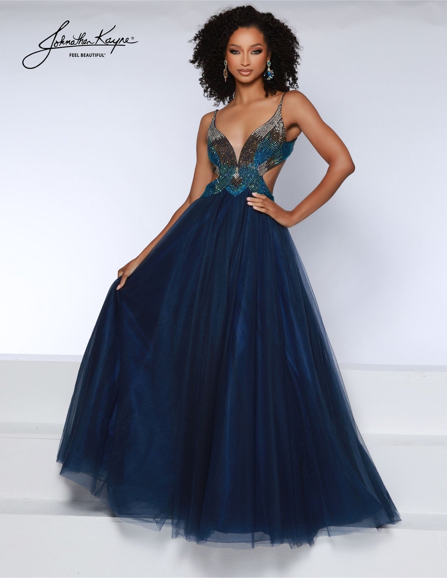 Make an unforgettable entrance with the Johnathan Kayne 2870 prom dress. A-Line tulle design features ombre stones, a plunging neckline, and elegant long cut. Make sure all eyes are on you at your formal event. A new take on classic ballgowns, the tulle gown features side cut outs and a daring back. Glisten like a star with the ombre stoning embellishments on the bodice that ensure you shine from every angle.