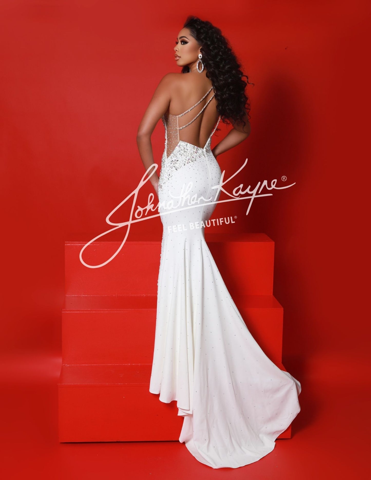 Elevate your formal look with the Johnathan Kayne 2923 Long One Shoulder Crystal Pageant Dress. Featuring a stunning one shoulder design and intricate crystal detailing, this dress exudes elegance and sophistication. The backless silhouette and thigh-high slit add a touch of sensuality, making it perfect for any special occasion. Turn heads in this stunning one shoulder gown featuring intricate beading and a thigh high slit.