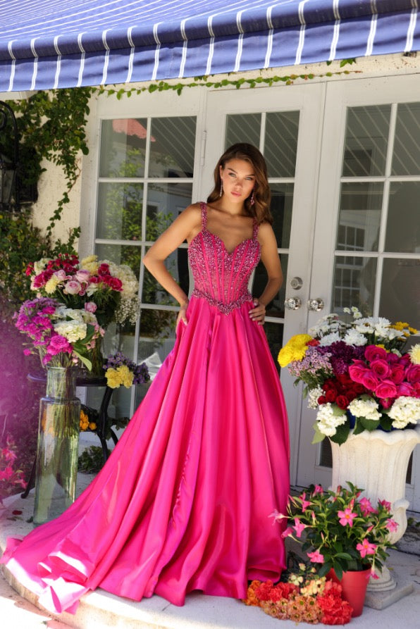 Get ready to stun in the Ava Presley 29521 Pageant Dress! With a long, sheer crystal corset and a flowing train, you'll feel like a true queen. Perfect for prom or any formal event, this ballgown will turn heads. Say yes to making a statement!