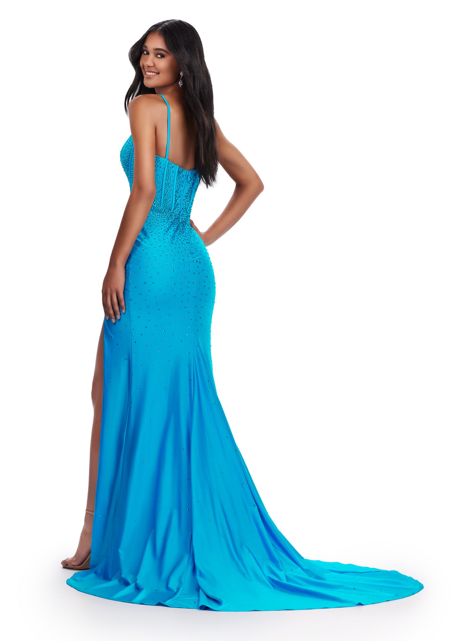 This Ashley Lauren 11668 prom dress is a sleek, fitted jersey gown with a corset bodice and plunging V-neckline. The dress also features a dramatic slit, adding a touch of sophistication and showcasing your legs. Perfect for formal events, this dress will make a stunning statement. 