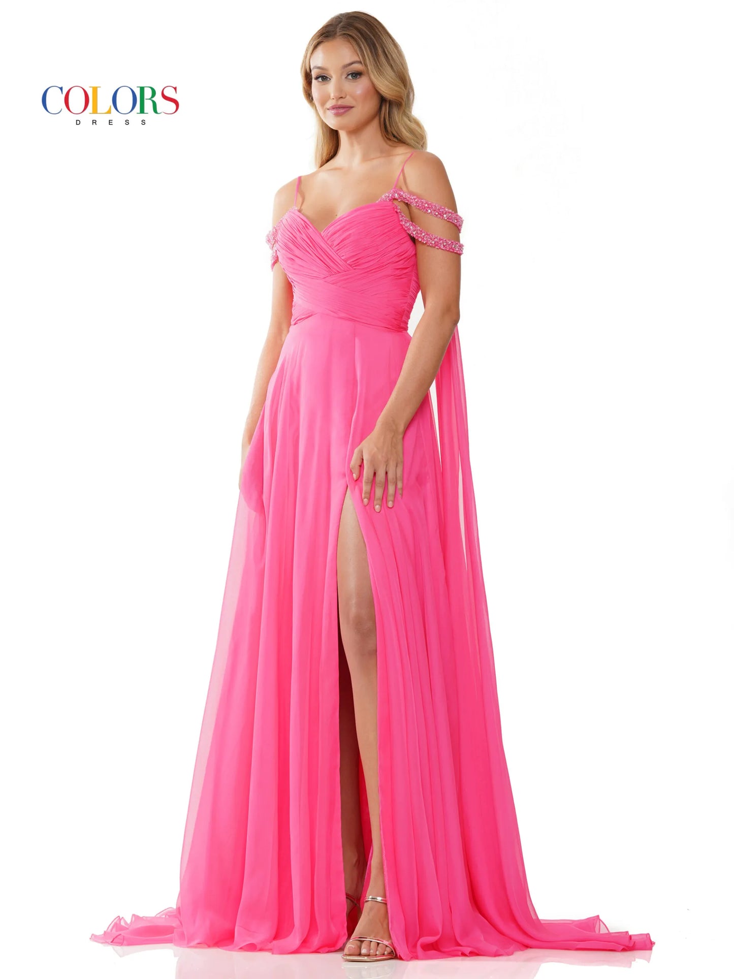 Elevate your style with the Colors Dress 3101 A Line Chiffon Pageant Dress. This stunning gown features an off the shoulder design and double beaded straps for a touch of elegance. The flowing chiffon cape adds a dramatic flair, while the maxi slit showcases your legs. Perfect for prom or any special occasion. corset back   Sizes: 0-20  Colors: Black, Royal, Deep Green, Hot Pink, Wine