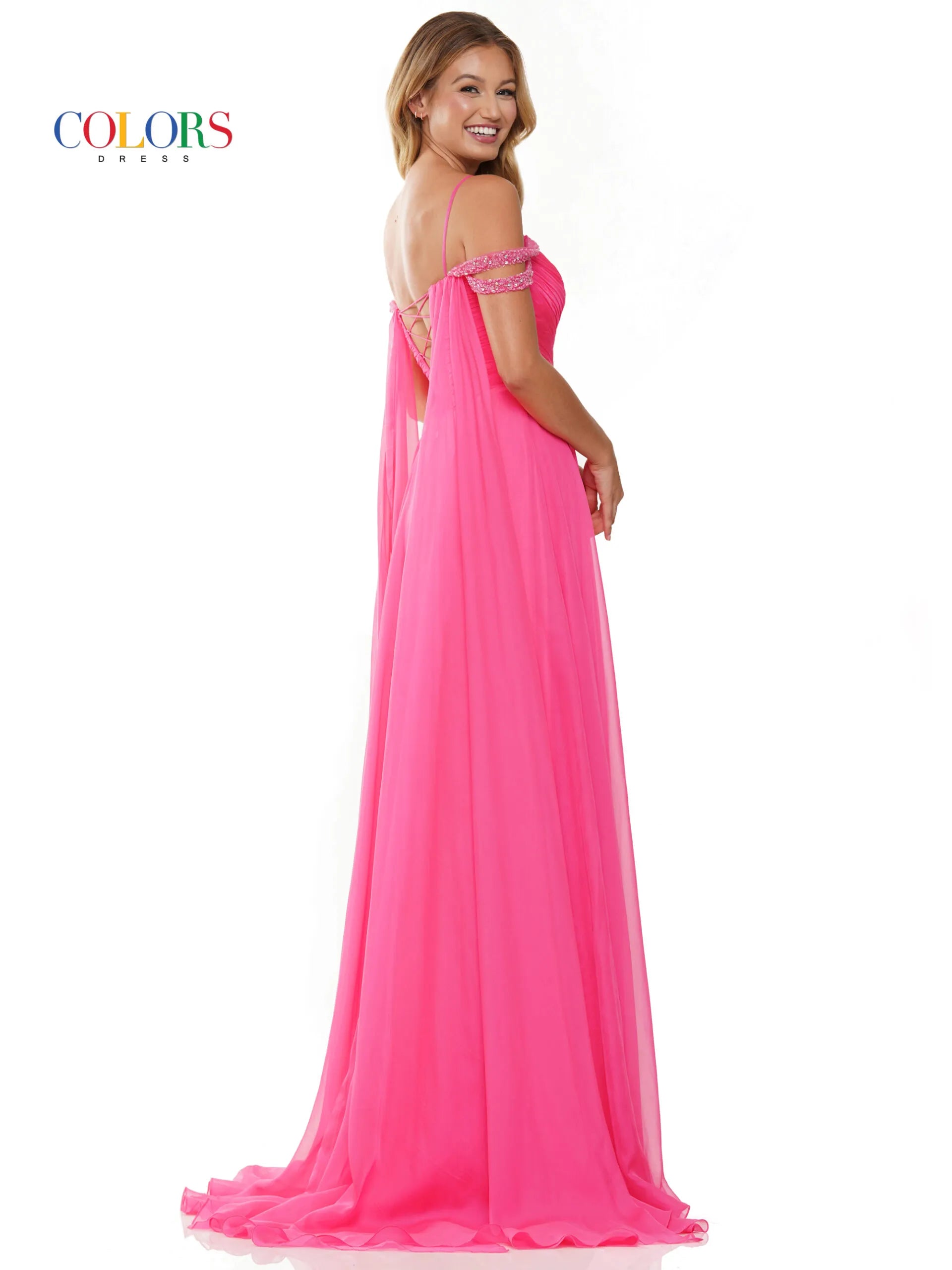 Elevate your style with the Colors Dress 3101 A Line Chiffon Pageant Dress. This stunning gown features an off the shoulder design and double beaded straps for a touch of elegance. The flowing chiffon cape adds a dramatic flair, while the maxi slit showcases your legs. Perfect for prom or any special occasion. corset back   Sizes: 0-20  Colors: Black, Royal, Deep Green, Hot Pink, Wine