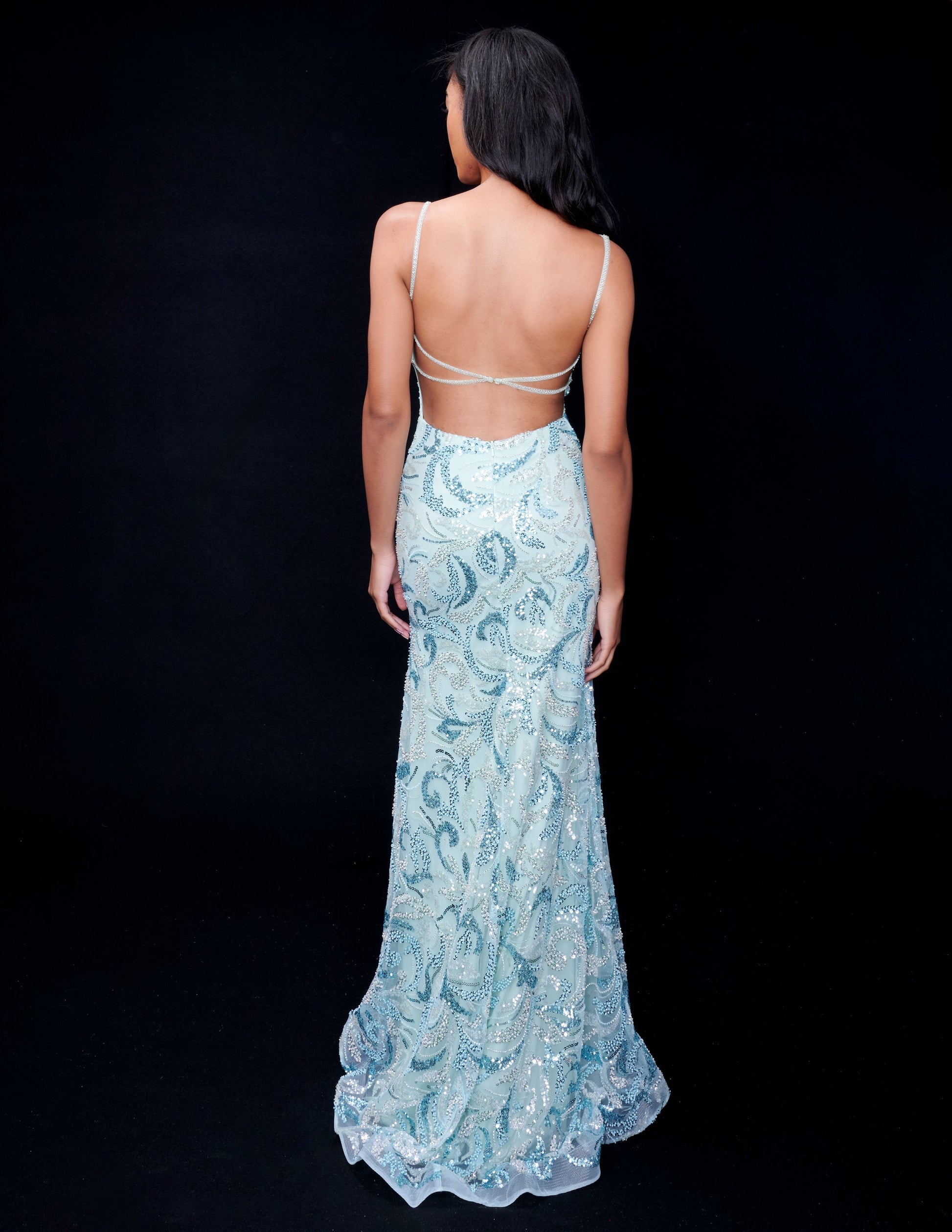 Nina Canacci presents an elegant formal dress for your next special occasion. With intricate beaded and sequin details, this backless gown features a stunning v-neck and thigh-high slit for a touch of glamour. Make a statement at prom or any evening event with this show-stopping design.