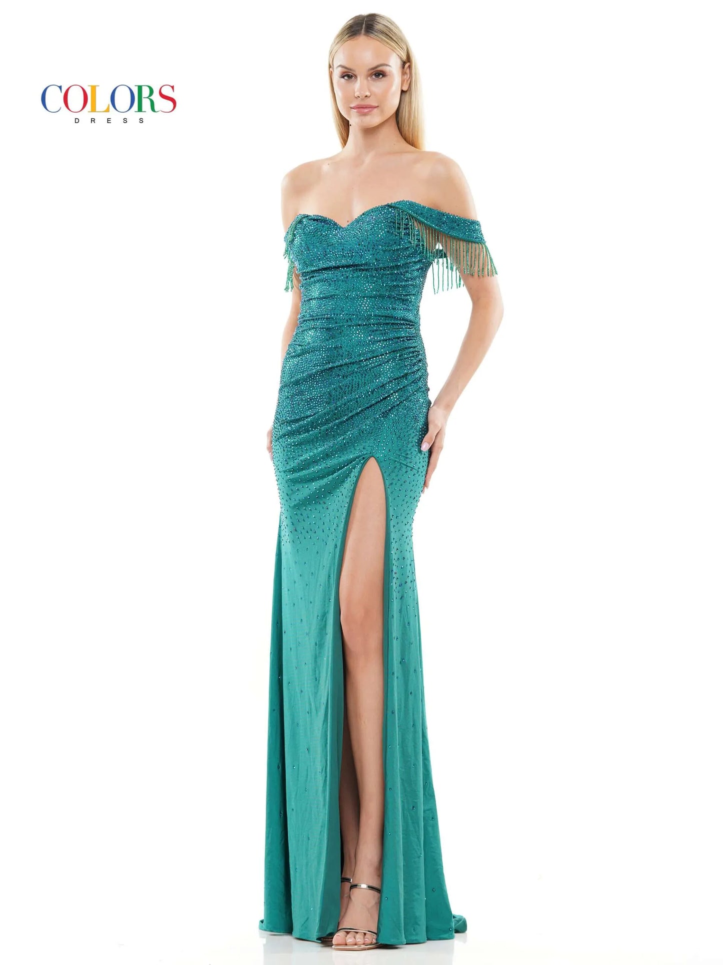 This glamorous formal dress from Colors Dress 3288 features off the shoulder fringe tassel sleeves, a crystal-studded bodice,  slit skirt, and a ruched waist detailing for a timeless and elegant look. Perfect for proms and special occasions.  Sizes: 0-22  Colors: Black, Deep Green, Turquoise