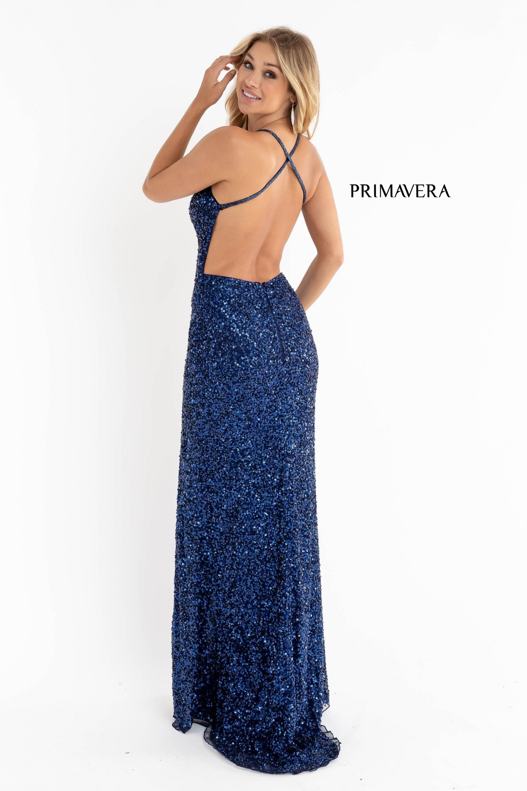 Primavera Couture 3291 Exclusive Prom Dresses.  This long prom dress is embellished throughout with shimmering sequins.  This impressive gown showcases a v neckline, thin beaded straps and crisscrossed straps in the open back. The long slim skirt has a sultry high side front slit. 