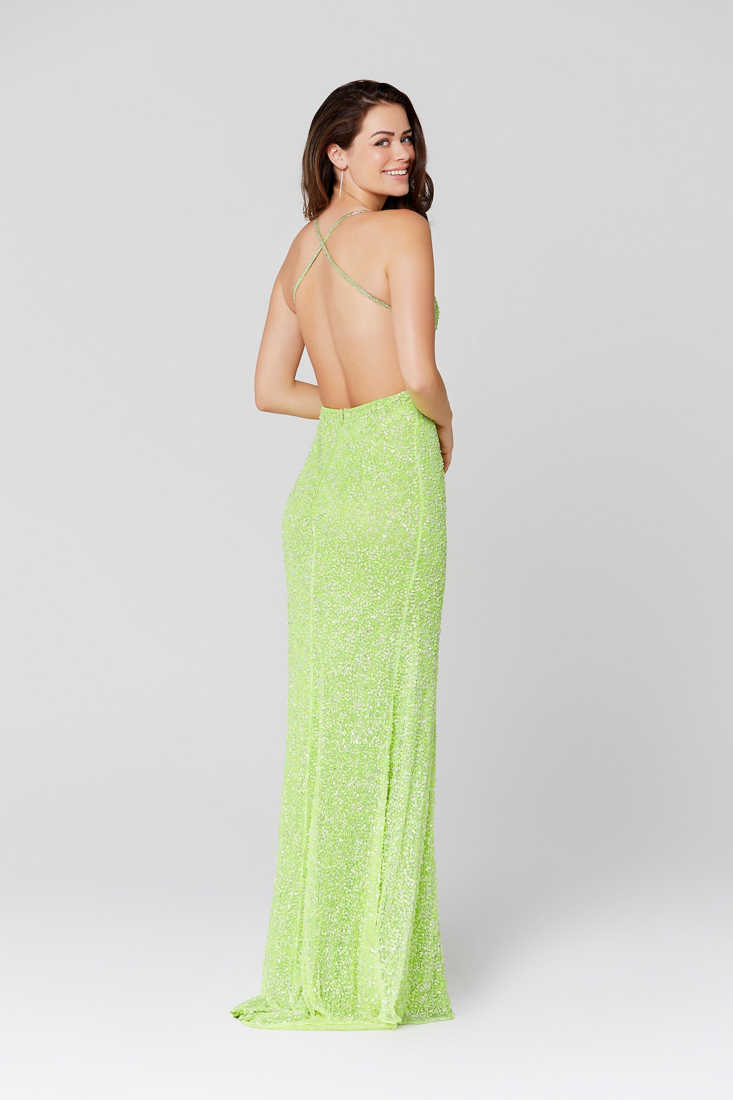 Primavera Couture 3291 Exclusive Prom Dresses.  This long prom dress is embellished throughout with shimmering sequins.  This impressive gown showcases a v neckline, thin beaded straps and crisscrossed straps in the open back. The long slim skirt has a sultry high side front slit. 