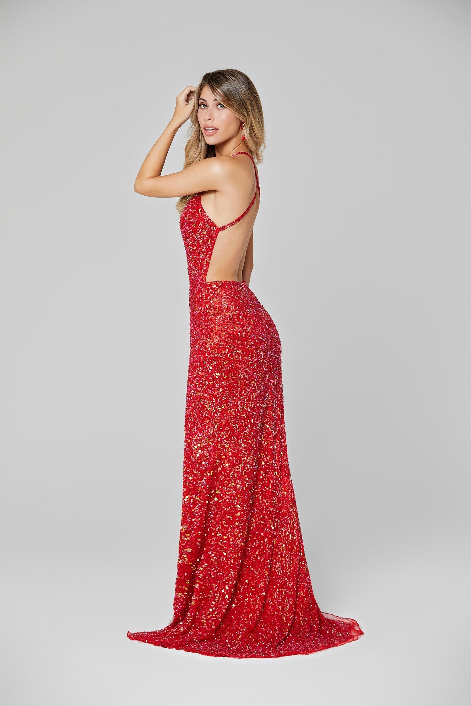 Primavera Couture 3291 Exclusive Prom Dresses.  This long prom dress is embellished throughout with shimmering sequins.  This impressive gown showcases a v neckline, thin beaded straps and crisscrossed straps in the open back. The long slim skirt has a sultry high side front slit. 