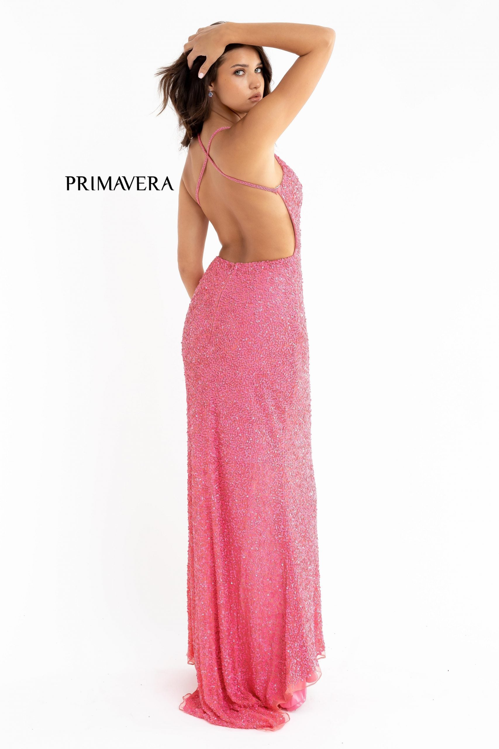 Primavera Couture 3291 Exclusive Prom Dresses.  This long prom dress is embellished throughout with shimmering sequins.  This impressive gown showcases a v neckline, thin beaded straps and crisscrossed straps in the open back. The long slim skirt has a sultry high side front slit. 