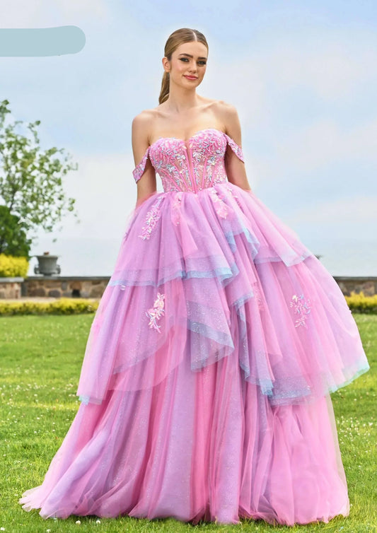 The Colors Dress 3534 is a stunning prom dress that features a modern off-the-shoulder design and a flattering sheer sequin corset. The layered multi toned ruffle and shimmering ball gown silhouette add a touch of elegance to your special occasion. With sheer details and high-quality materials, this formal dress is sure to make you stand out from the crowd.