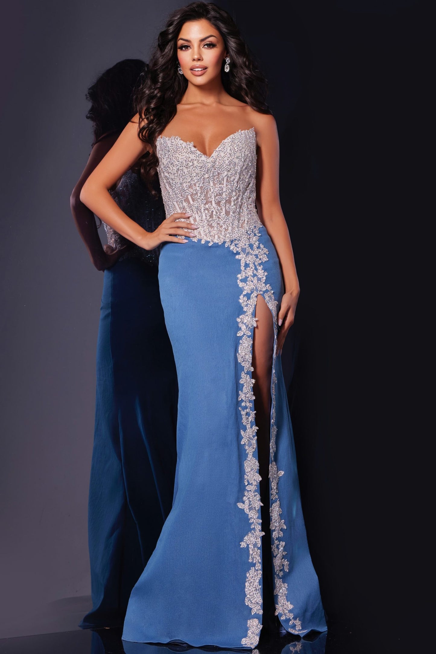 Introducing the stunning Jovani 43341 Prom Dress, featuring a sheer lace and crystal corset design. The strapless style adds a touch of elegance, while the slit adds a modern twist. Perfect for pageants and prom, this dress is guaranteed to make you stand out. DENIM