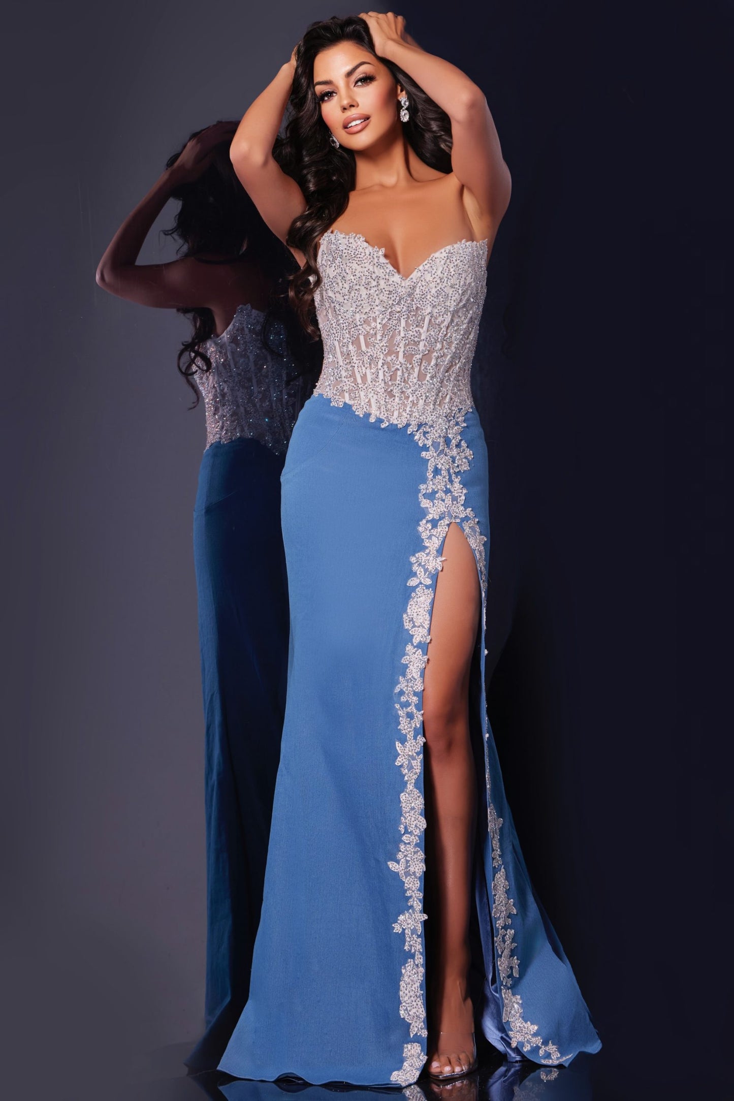 Introducing the stunning Jovani 43341 Prom Dress, featuring a sheer lace and crystal corset design. The strapless style adds a touch of elegance, while the slit adds a modern twist. Perfect for pageants and prom, this dress is guaranteed to make you stand out. DENIM