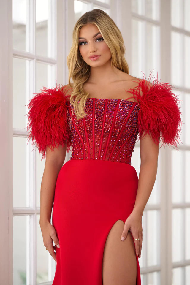 Experience the ultimate elegance in the Ava Presley 39279 Long Prom Dress. The off-shoulder feather gown is enhanced by a sheer corset bodice, perfect for formal events and pageants. Channel your inner beauty with this luxurious and show-stopping piece.