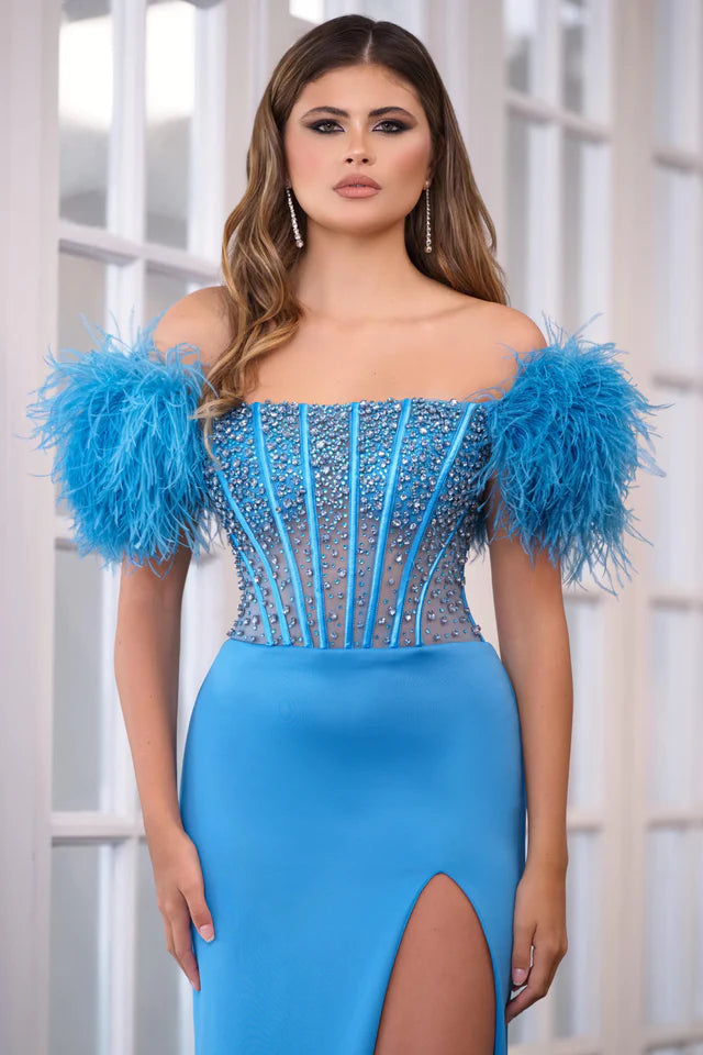 Experience the ultimate elegance in the Ava Presley 39279 Long Prom Dress. The off-shoulder feather gown is enhanced by a sheer corset bodice, perfect for formal events and pageants. Channel your inner beauty with this luxurious and show-stopping piece.