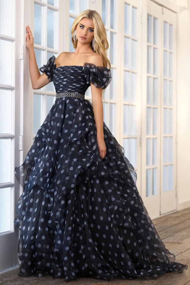 This Ava Presley 39318 prom dress is the perfect choice for any formal occasion. Its off the shoulder design and open back add a touch of elegance, while the layered organza ruffles create a unique and flattering silhouette. Turn heads and feel confident in this stunning pageant gown.