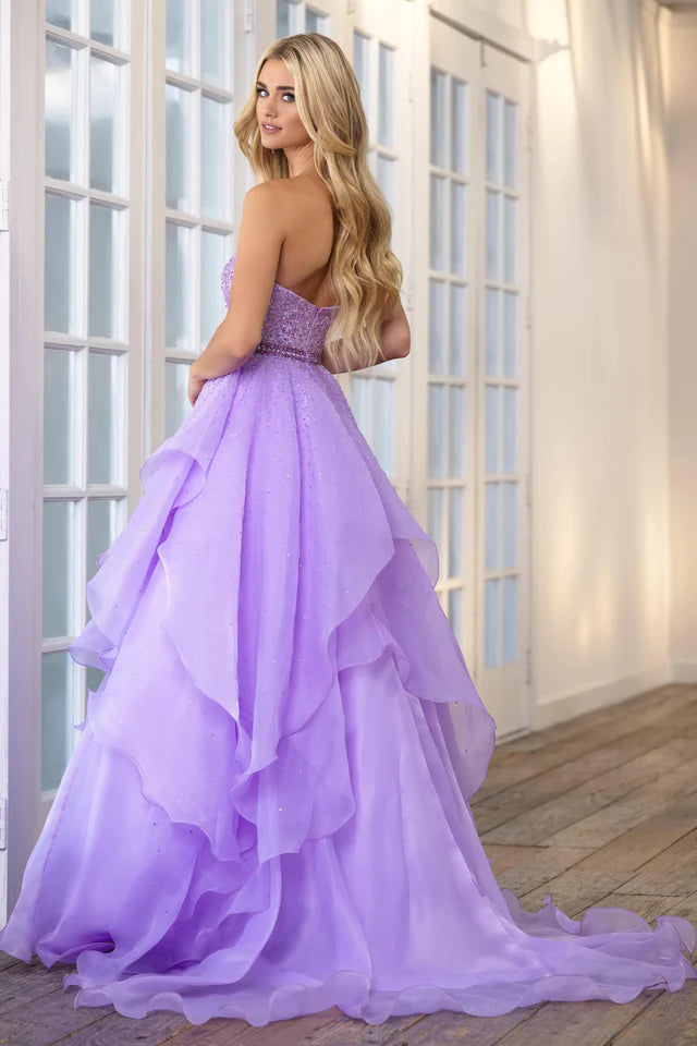 Add a touch of elegance to any formal event with the Ava Presley 39561 Long Prom Dress. The beaded bodice and halter top provide a dazzling look, while the crystal belt-line and layered ruffles add texture and movement. Perfect for prom, pageants, or any special occasion.