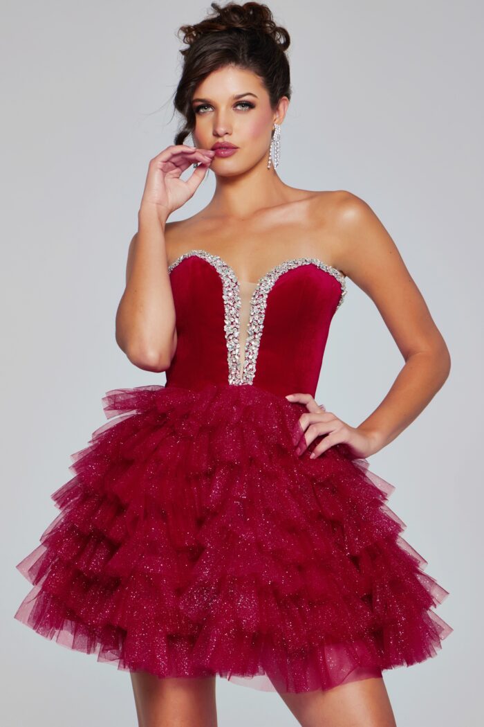 Expertly designed by Jovani, the 40352 Velvet Short Cocktail Dress offers a stunning combination of velvet bodice and layered tulle skirt. The strapless sweetheart neckline is adorned with sparkling crystals, making this gown perfect for homecoming or pageant events.