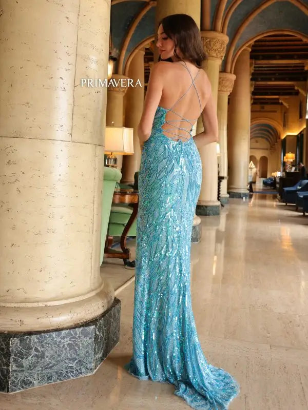 This Primavera Couture 4121 Long Prom Dress is designed with a corset and plunging neckline for a flattering and alluring fit. The high slit adds a touch of daring elegance, while the sequin embellishments provide a glamorous look. Perfect for prom, pageants, or any formal event.