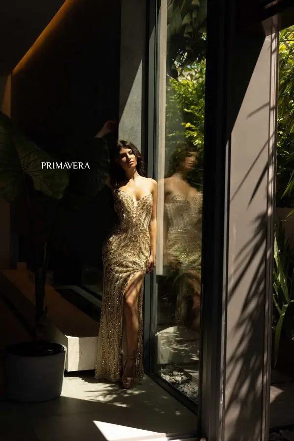 Expertly designed by Primavera Couture, the 4134 Long Prom Dress combines a sequined, fitted silhouette with a high slit and strapless design for a formal, pageant-worthy look. Stand out from the crowd with this elegant gown, perfect for a glamorous night out or special occasion.