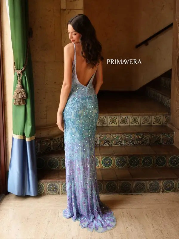 Flaunt your figure in the Primavera Couture 4150 Long Prom Dress. The beaded sequin detailing on this fitted gown adds a touch of glamour, while the high slit and open back provide a sexy yet elegant look. Perfect for any formal event, this gown will make you the center of attention.