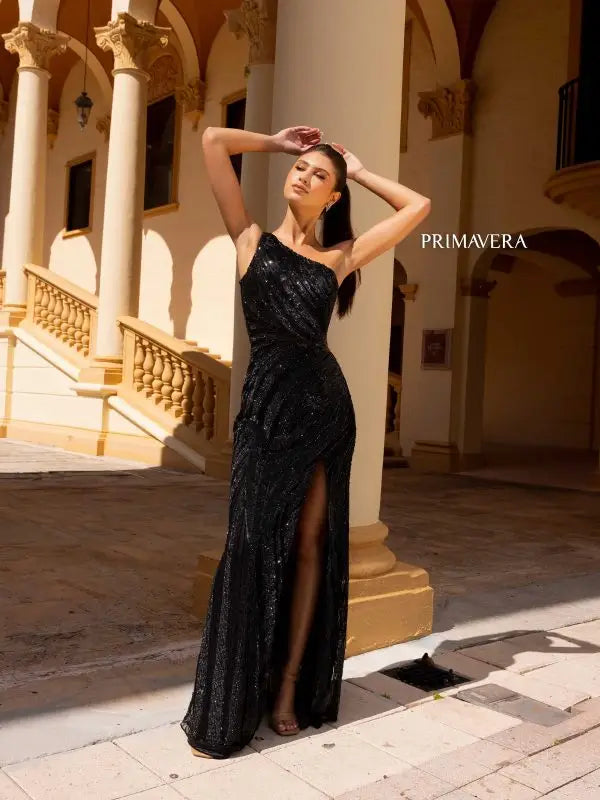 Elevate your formal pageant look with the Primavera Couture 4152 gown. Its lace-up back, high slit, and beaded sequin details create a stunning and fitted silhouette. The asymmetrical design adds a unique touch to this elegant dress. Shine like a star on stage with this beautifully crafted gown.