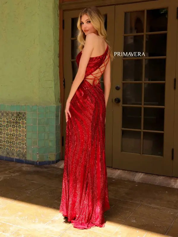 Elevate your formal pageant look with the Primavera Couture 4152 gown. Its lace-up back, high slit, and beaded sequin details create a stunning and fitted silhouette. The asymmetrical design adds a unique touch to this elegant dress. Shine like a star on stage with this beautifully crafted gown.