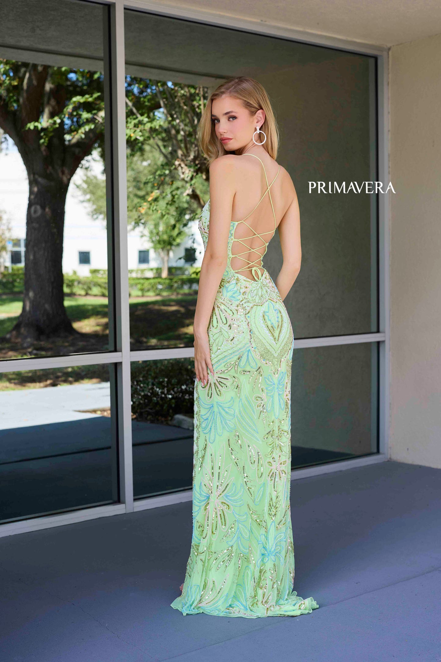 This Primavera Couture 4156 Long Prom Dress is the perfect choice for a sophisticated and glamorous look. With a fitted silhouette and scoop neck, this dress accentuates your curves while the sequin details add a touch of sparkle. The lace-up back and high slit provide a flattering and elegant touch, making it a must-have for formal occasions and pageant events.