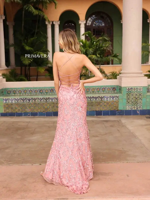 Step into the spotlight in the Primavera Couture 4161 Prom Dress. With dazzling sequin details and a figure-flattering fit, this dress is sure to turn heads. The high slit adds a touch of drama, while the lace-up back adds an extra element of style. Perfect for any formal event.